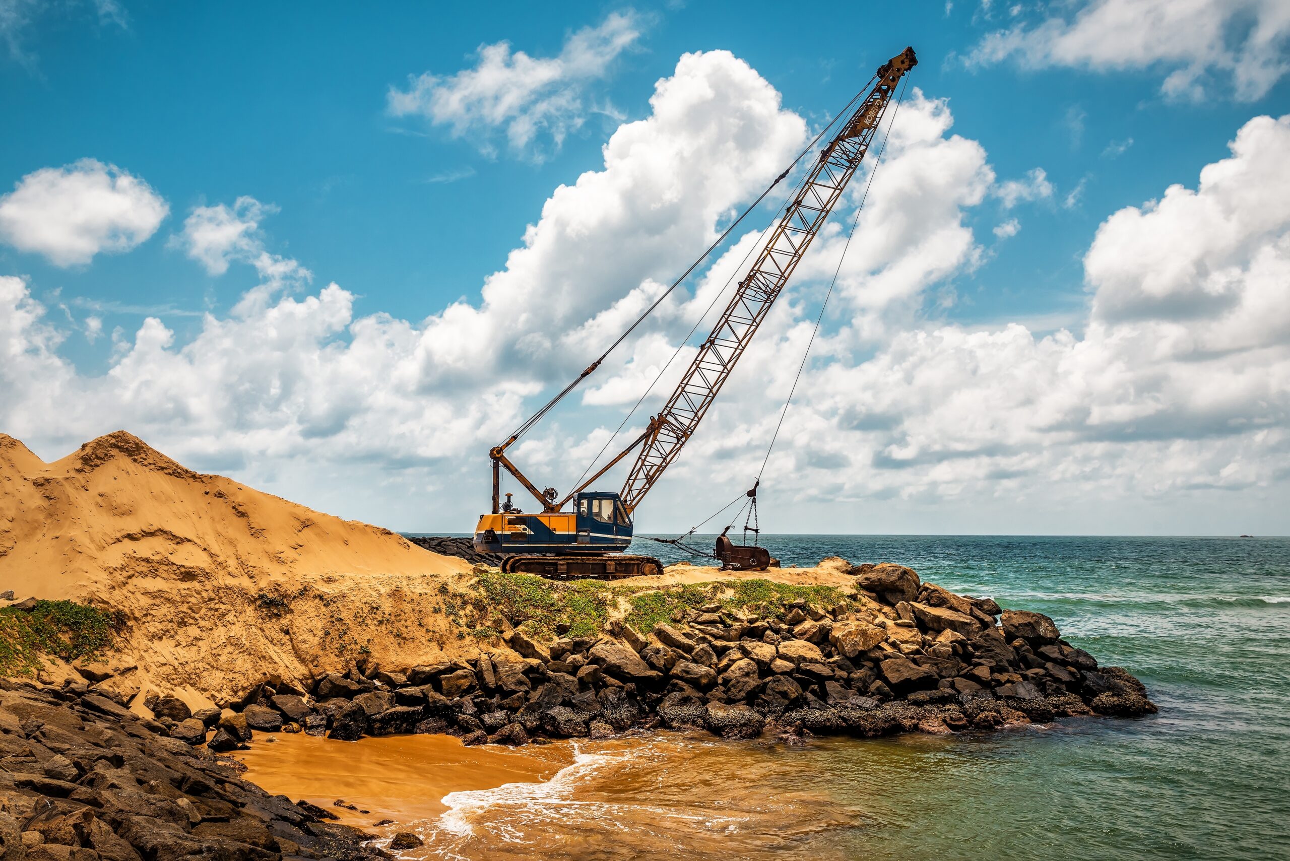 Dragline, Excavator working at seafront